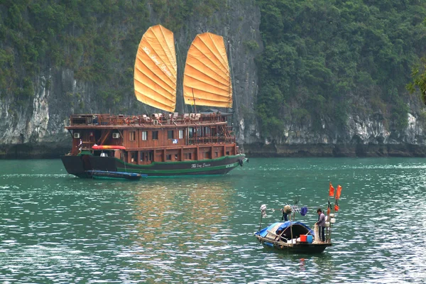 Fishing boat and tourist argosy in Halong Bay. — Stock Photo, Image