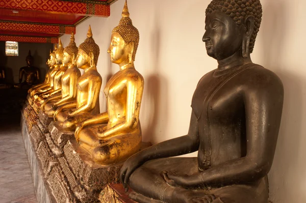 Group of Buddhas in the wall at church . — Stock Photo, Image