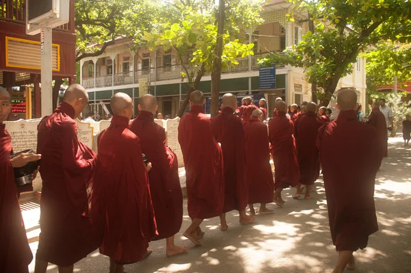 Rij van boeddhistische monniken wachten lunch in Myanmar. — Stockfoto