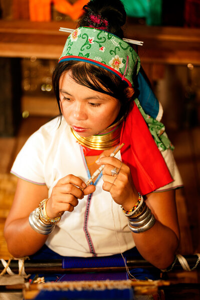 Portrait of Kayan Lahwi  girl is weaving.