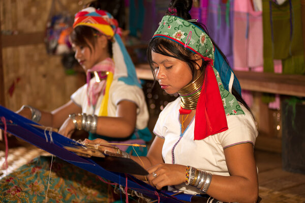 Two Kayan  Lahwi girls are  weaving.