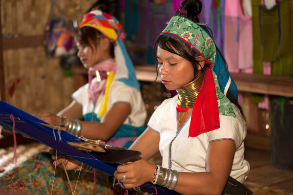 Two Kayan  Lahwi girls are  weaving.