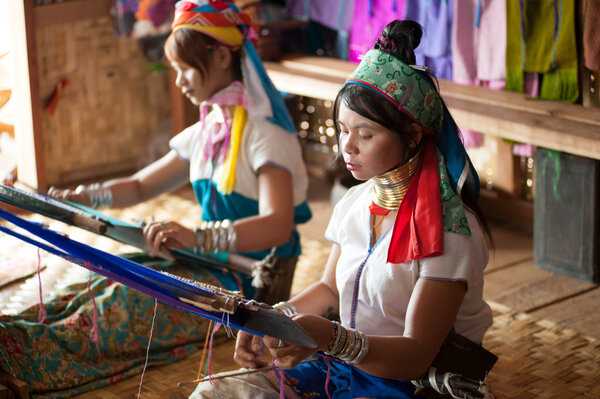 Two Kayan  Lahwi girls are  weaving.