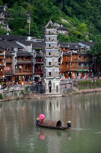 Tujia ethnic minority singing show on boat in river.