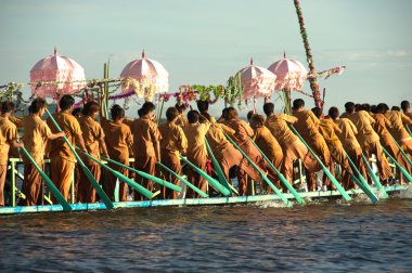 Peoples paddle by legs in Phaung Daw Oo Pagoda festival,Myanmar.