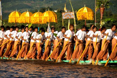 Peoples paddle by legs in Phaung Daw Oo Pagoda festival,Myanmar.