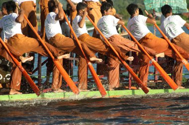 Peoples paddle by legs in Phaung Daw Oo Pagoda festival,Myanmar.