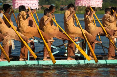 Peoples paddle by legs in Phaung Daw Oo Pagoda festival,Myanmar.