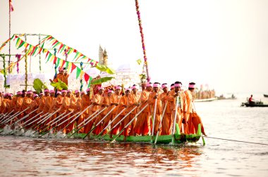 Peoples paddle by legs in Phaung Daw Oo Pagoda festival,Myanmar.