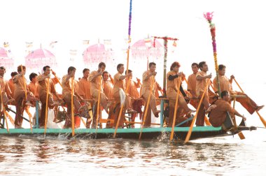 Peoples paddle by legs in Phaung Daw Oo Pagoda festival,Myanmar.