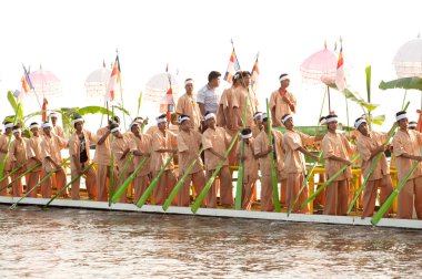 Peoples paddle by legs in Phaung Daw Oo Pagoda festival,Myanmar.
