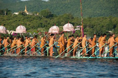 Peoples paddle by legs in Phaung Daw Oo Pagoda festival,Myanmar.