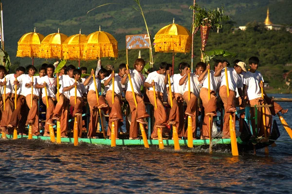 Peoples paddle by legs in Phaung Daw Oo Pagoda festival,Myanmar.