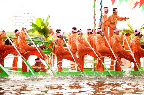 Peoples paddle by legs in Phaung Daw Oo Pagoda festival,Myanmar.