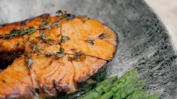 アスパラで装飾されたプレートの上に横たわる美しいマス 野菜の魚料理がテーブルの上に 美食だ グルメ — ストック動画