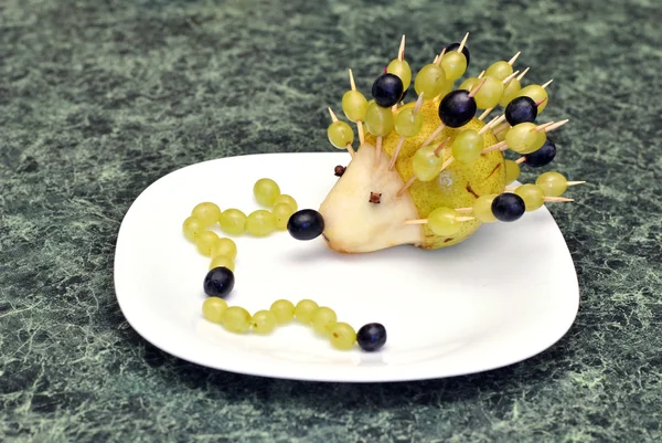 Funny figure hedgehog and caterpillars of fruit for children food, made by a child's hand — Stock Photo, Image