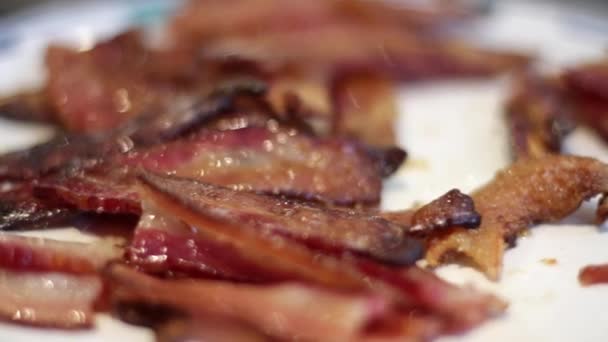 Close up of bacon on plate after cooking.  Macro shot with hand held camera. Stock Video