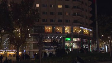 Madrid, İspanya, Noel, 12-14-2025: Torre de Madrid gökdelenini ve bir restoran dolusu insanı gösteren kamera hareketi