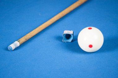 Bilardo topları, işaret ve tebeşir mavi bir bilardo masası üzerinde. Her bakıldığında 