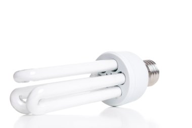 Energy saving fluorescent light bulb, isolated on white backgrou clipart