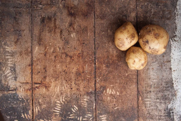 Raw potato food . Fresh potatoes on wooden background. Free plac