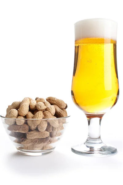 Pint of lager and peanuts on white background Stock Picture