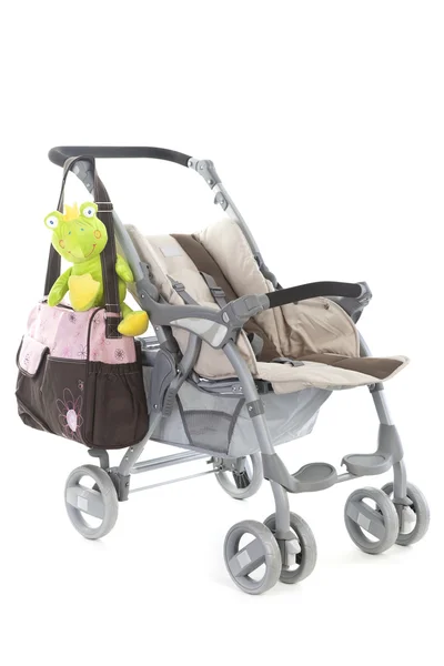 Kinderwagen met tassen, en speelgoed — Stockfoto