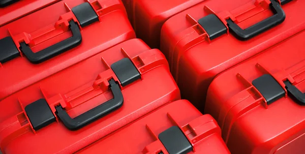 Red packing plastic boxes cases for geodetic total stations. Horizontal pattern of boxes for surveying instruments. View from above