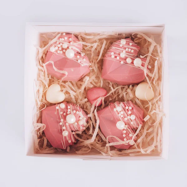 Pink heart-shaped cake in a box. Gift for Valentine's Day and Women's Day.