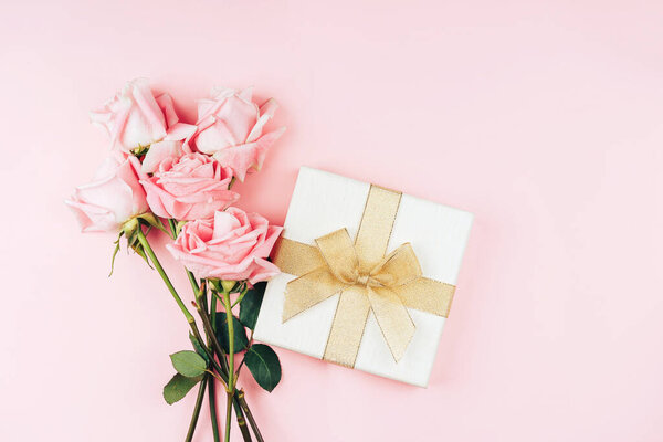 Beautiful bouquet of red roses against pink background. Holiday gift valentine day, 14 february, March 8, Mothers day.