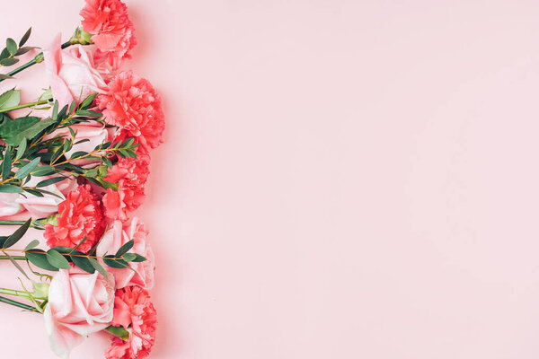 Beautiful bouquet of roses in front of pink background. Free space for text.