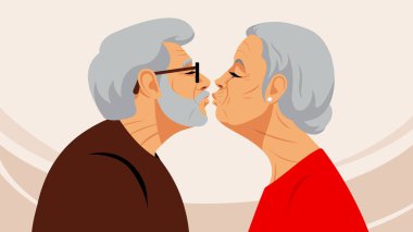 Olgun bir çift öpüşüyor. Yaşlı bir adam ve yaşlı bir kadın dudaklarını birbirine değdirirler. Sevgi, şefkat ve birlikteliğin dokunaklı sahnesi. Aşıkların silueti. Olgun yaşta aşk ve sağlık kavramı.
