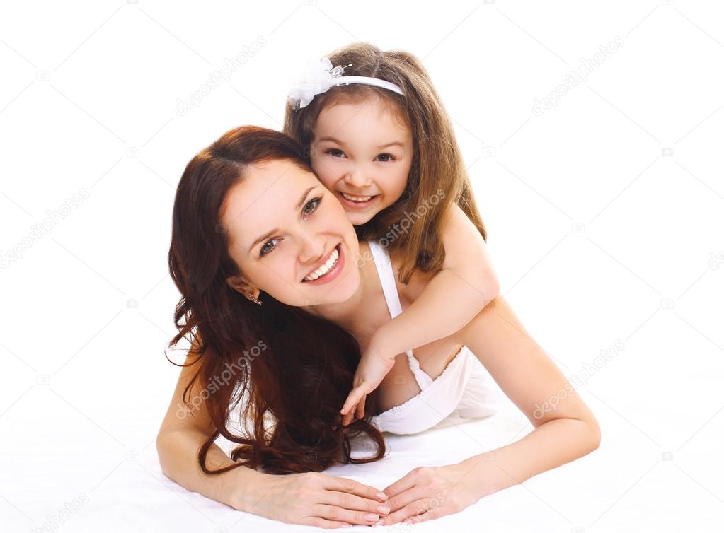 Happy smiling mother and little child daughter on a white backgr