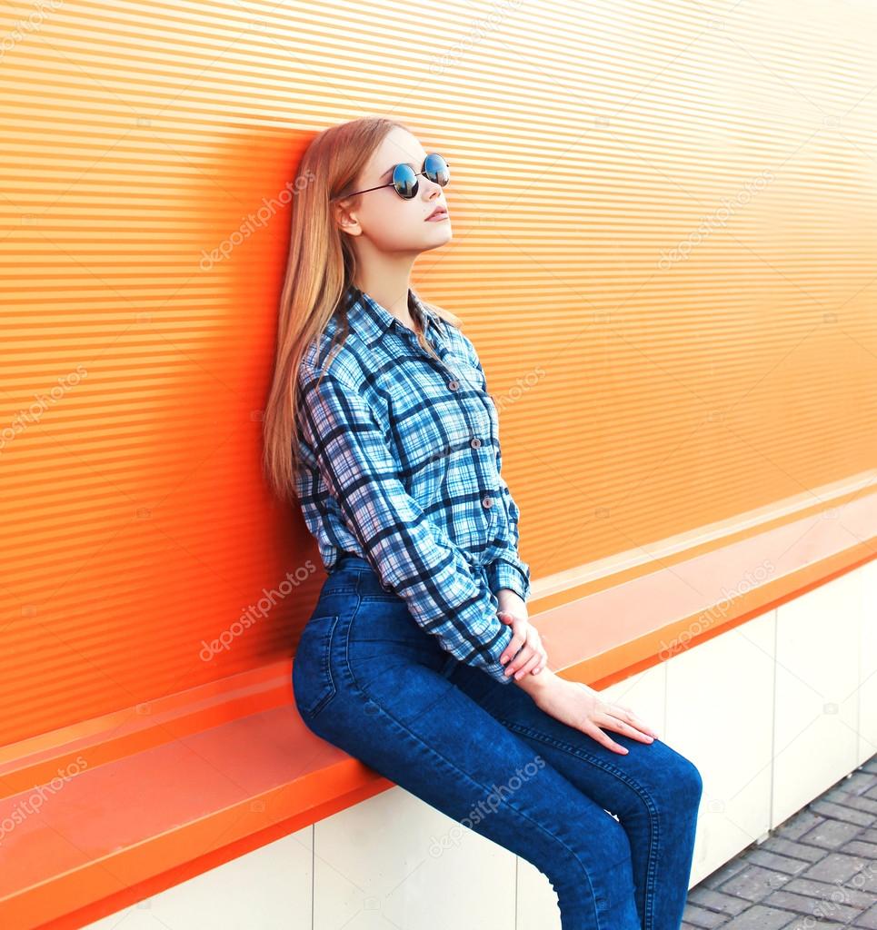 Fashion pretty blonde girl over colorful orange background