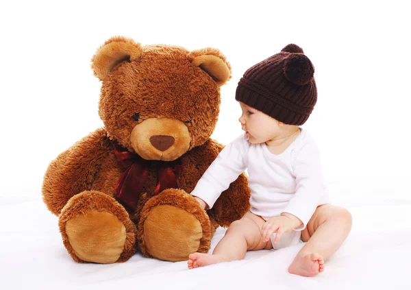 Baby spielt mit großem Teddybär-Spielzeug auf weißem Hintergrund — Stockfoto