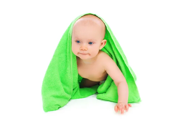 Portrait of little baby under towel crawls on white background — Stock Photo, Image