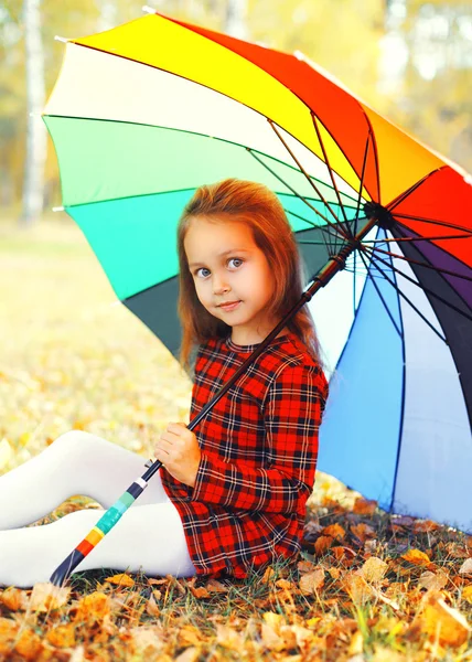 Portrait little girl child with colorful umbrella in sunny autum — Stock Photo, Image