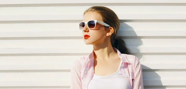 身穿白衬衫 戴着太阳镜的年轻女子的画像 — 图库照片