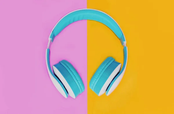 Close Blue Headphones Colorful Pink Yellow Background Top View — Stock Photo, Image