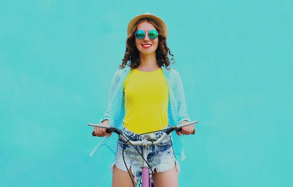 幸せな若いです笑顔の女性で自転車で青い背景 — ストック写真