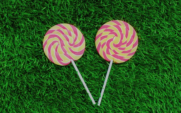Close Two Colorful Lollipop Stick Lying Green Grass Background — Stock Photo, Image