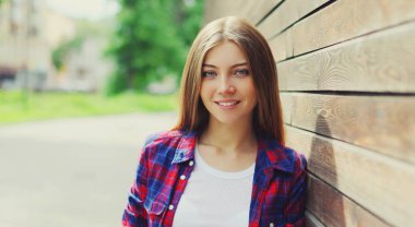 Portrait close up of beautiful young woman posing in a city