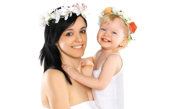 Mother and child smiling with flower wreaths on their heads, hap — Stock Photo, Image