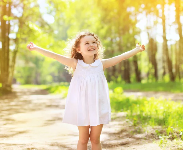 Positive charming curly little girl enjoying summer sunny day, e — Stock Photo, Image