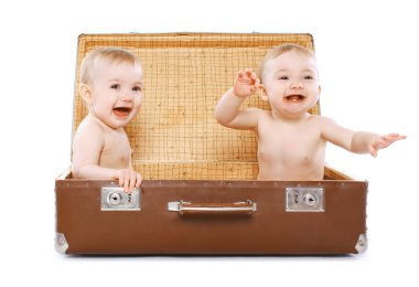 Two cheerful twins sitting in a suitcase having fun, travel, fam clipart