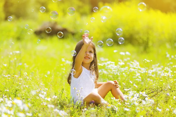 Criança se divertindo no dia de verão, bolhas de sabão — Fotografia de Stock