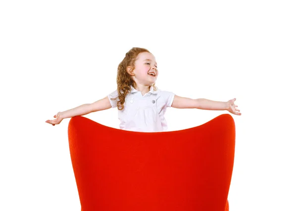 Alegre niña en silla roja —  Fotos de Stock