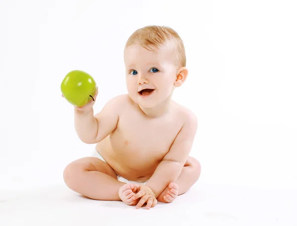 Niedlich charmant lächelndes Baby mit grünem Apfel — Stockfoto