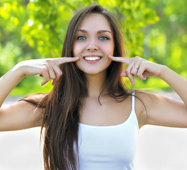 Portrait of a charming cute girl smiling and showing thumbs — Stock Photo, Image