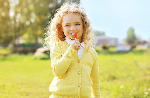 Little child with sweets outdoors — Stock Photo, Image